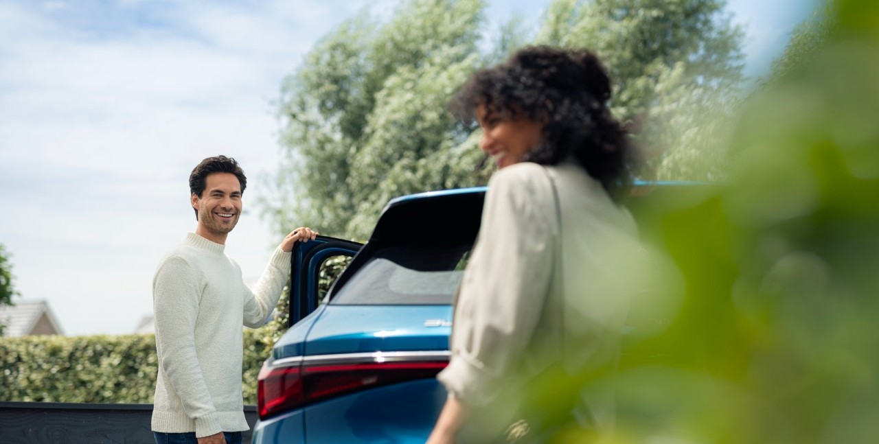 Man and woman stood by a car